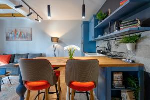 a living room with a wooden table and two chairs at Apartment ERAK HILL in Zlatibor