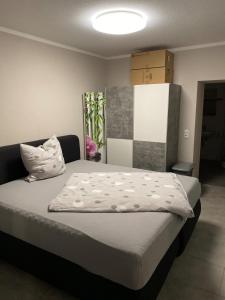 ein Schlafzimmer mit einem Bett mit einer weißen Bettdecke in der Unterkunft Ferienwohnung am Dornheimer Berg in Arnstadt