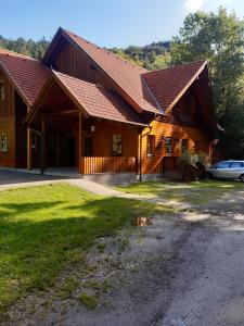 ein großes Holzhaus mit einem Auto davor geparkt in der Unterkunft Schutzhaus Johannesbachklamm in Unterhöflein