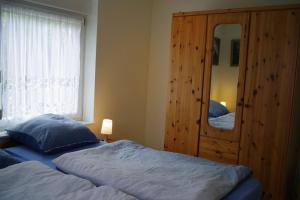 een slaapkamer met een bed en een grote spiegel bij Ferienwohnung Schuur - Buchholz in der Nordheide in Buchholz in der Nordheide