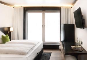 A bed or beds in a room at TO Hotel by WMM Hotels