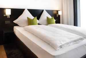 A bed or beds in a room at TO Hotel by WMM Hotels