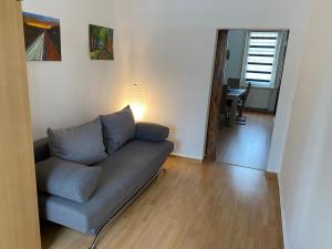 uma sala de estar com um sofá e uma mesa em Ferienwohnung Eichhörnchen em Suhl