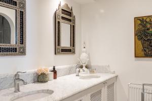 a bathroom with two sinks and a mirror at Molenmeers Boutique Guesthouses in Bruges