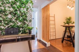 a living room with a wall covered in plants at Santos Mattos Guesthouse & Apartments by Lisbon with Sintra in Amadora