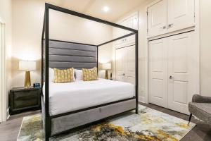 a bedroom with a black and white canopy bed at The Calliope in New Orleans