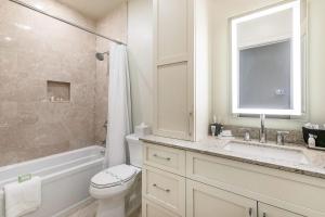 a bathroom with a toilet and a sink and a shower at The Calliope in New Orleans