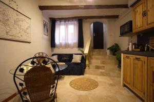 a living room with a couch and a table at Les Secrets d'Alcôve, nuits Romantiques avec SPA in Aix-en-Provence