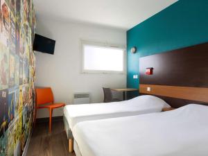 A bed or beds in a room at hotelF1 Longwy