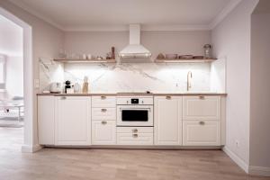 een keuken met witte kasten en een fornuis bij Boutique Charme Apartments in Baden-Baden