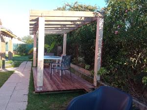 une terrasse en bois avec une table et des chaises. dans l'établissement T3 L'Olivier & Jardin 1 à 4 Pers à Villa Terra, à Balma