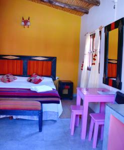 A bed or beds in a room at Hostal Paseo de los Colorados