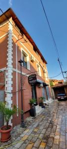 a large building with a street in front of it at CityCenterHotel Shkoder in Shkodër