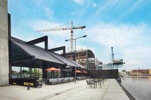 a building with tables and chairs and a crane at Inntel Hotels Amsterdam Landmark in Amsterdam