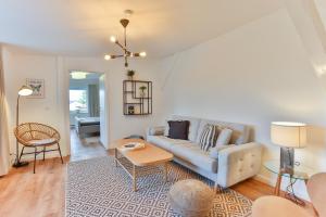 a living room with a couch and a table at Apartmenthaus Tribseer Damm 6 in Stralsund