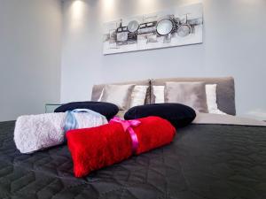 a bedroom with a bed with pillows on it at Apartment Apex penthouse self check-in in Karlovac