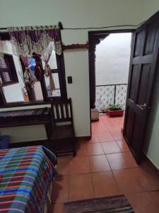 a room with a bed and an open door at Hotel Vista al Cerro in Antigua Guatemala