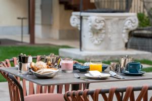 a table with breakfast foods and drinks on it at Ca'di Dio-Small Luxury Hotel in Venice