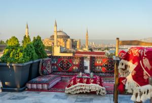 a balcony with colorful furniture and a view of the mosque at World Heritage Center Hotel in Istanbul