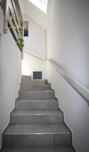 a staircase in a white building with a television at Apartmány Amália in Piešťany