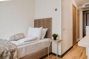 a bedroom with a bed and a side table at ОРАНТА in Truskavets