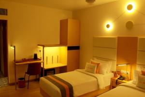 A bed or beds in a room at Zone Connect by The Park Coimbatore