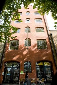 a woman walking in front of a brick building at YHA Bristol in Bristol