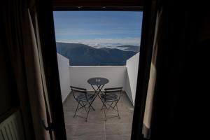 a view of a table and chairs on a balcony at Ellinon Thea Arachova in Arachova