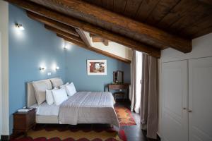 a bedroom with a large bed with blue walls at Ellinon Thea Arachova in Arachova