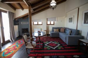 a living room with a couch and a table at Ellinon Thea Arachova in Arachova