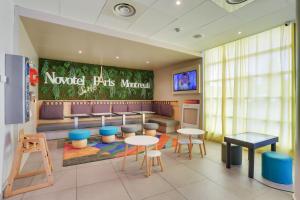 a restaurant with a waiting room with tables and chairs at Novotel Suites Paris Montreuil Vincennes in Paris