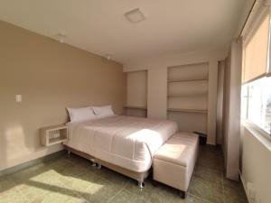 a bedroom with a large bed and a window at Lilium Apartment & Experiences in Arequipa