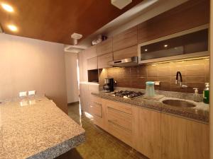 a kitchen with a sink and a counter top at Lilium Apartment & Experiences in Arequipa