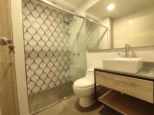 a bathroom with a toilet and a sink and a shower at Lilium Apartment & Experiences in Arequipa