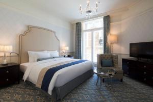 a bedroom with a large bed and a television at The Tokyo Station Hotel in Tokyo