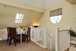 a dining room with a table and chairs at Self contained accommodation near Delamere forest in Oakmere