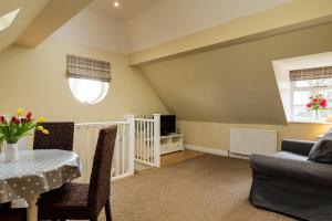 a living room with a table and a couch at Self contained accommodation near Delamere forest in Oakmere