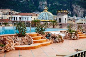 een resort met een zwembad, een trap en een gebouw bij Grand Hotel La Favorita in Sorrento