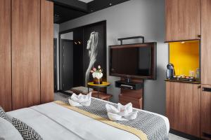 A bed or beds in a room at Hotel Panoramika Design & Spa