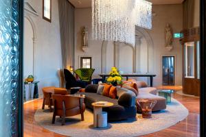 a living room with a couch and chairs and a chandelier at Ca'di Dio-Small Luxury Hotel in Venice