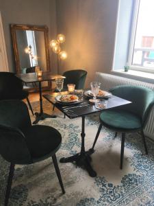 a room with a table with plates of food on it at Clos Terre-lune in Nuits-Saint-Georges