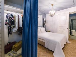 a bedroom with a bed and a blue curtain at The Soul Istanbul Hotel in Istanbul