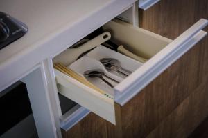 a drawer in a desk with some tools in it at Blue Entrance in Onna