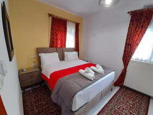 a bedroom with a bed with two towels on it at Zosimas House in Kalabaka