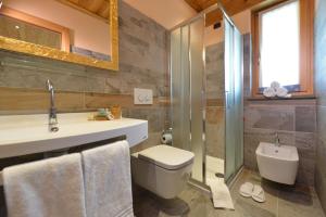 a bathroom with a toilet and a sink and a shower at Miravalle in Antey-Saint-André