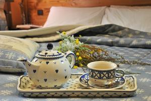 a tea set on a tray with a teapot and a cup at Miravalle in Antey-Saint-André