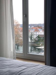 um quarto com uma janela com vista para um rio em Metropol Apartments & Suites em Tübingen