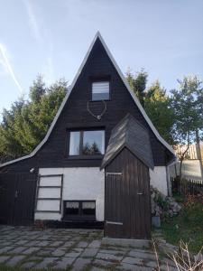 a black and white house with a garage at Ferienhaus Wittmann in Kurort Oberwiesenthal