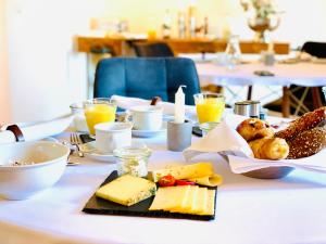 a table with cheese and other foods on it at RotmeerHaus in Feldberg