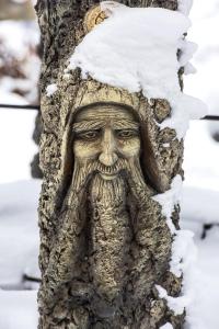 a statue of an old man hugging a tree at Stara Pravda Villas in Bukovel